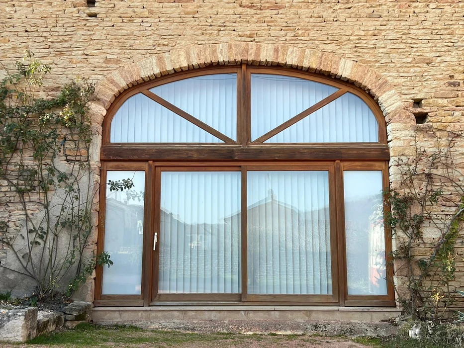Terrasse extérieure moderne avec store banne déployé gris anthracite fixé sur façade contemporaine