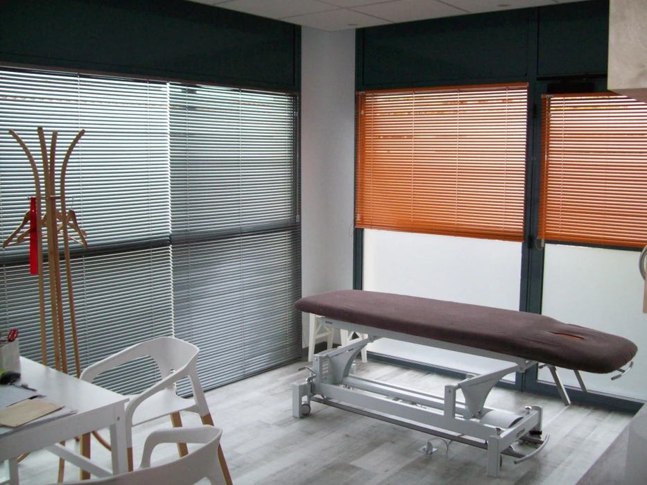 Terrasse extérieure avec store banne beige déployé offrant protection solaire au-dessus d'une balustrade métallique ornementée